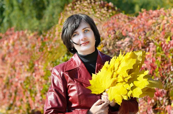 Beautiful woman with yellow leaves