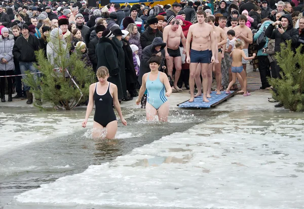 Christian religious festival Epiphany. People bathe in the river in winter .