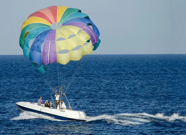 Rest on the Red Sea. People on the boat uncovered colorful multicolored parachute.