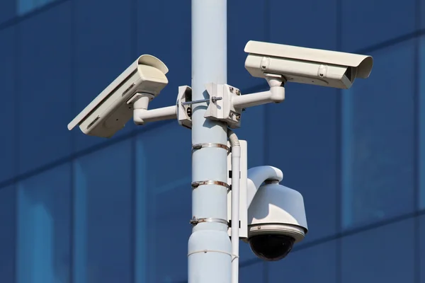 Three cctv security cameras on street pylon