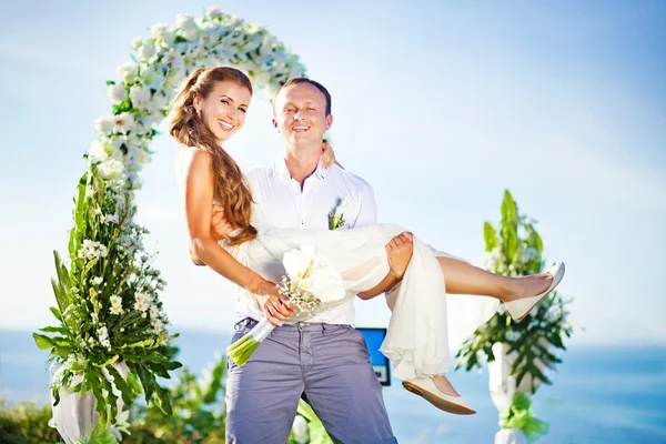 Cheerful bride and groom on the wedding venue outdoors