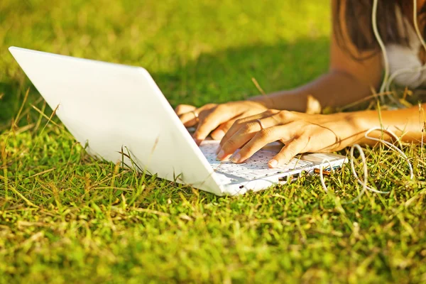 Young woman on the grass in park or garden