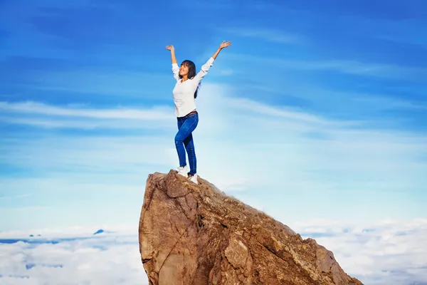 Woman on a mountain peak