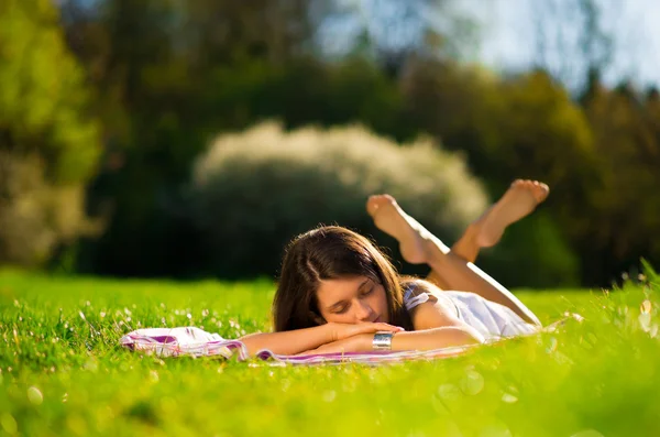 Young Woman sleep on beautiful green grass