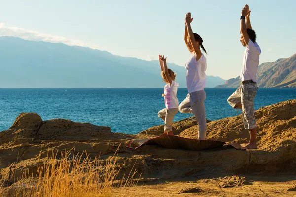 Family doing yoga exercise