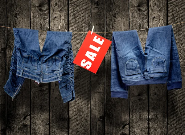 Jeans, sale inscription on clothesline