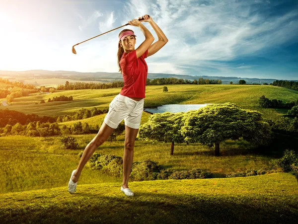 Woman golfer hitting the ball on the beautiful background scenery