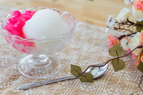 White ice cream made from coconut and pink jelly topping on the