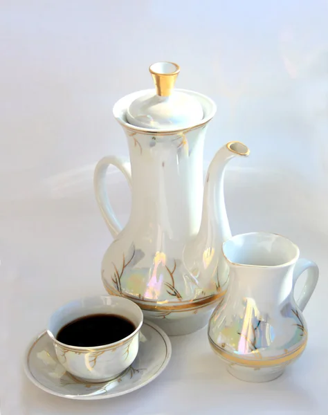 Jug, coffee pot and cup of coffee.