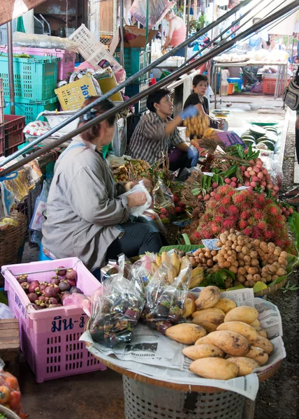 Street vendors on famous Maeklong Railway Market, Thailand