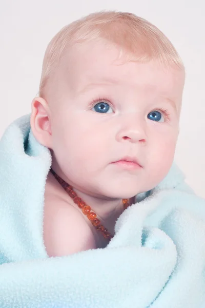 Blonde baby in blue blanket