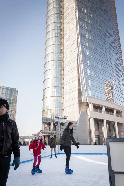 People skating on ice rink in Milan, Italy