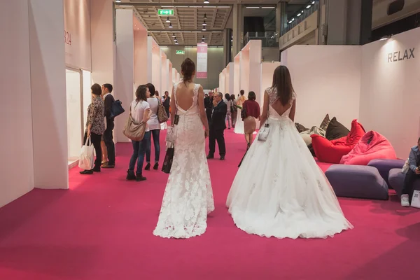 Models wearing wedding dresses at Si' Sposaitalia in Milan, Italy