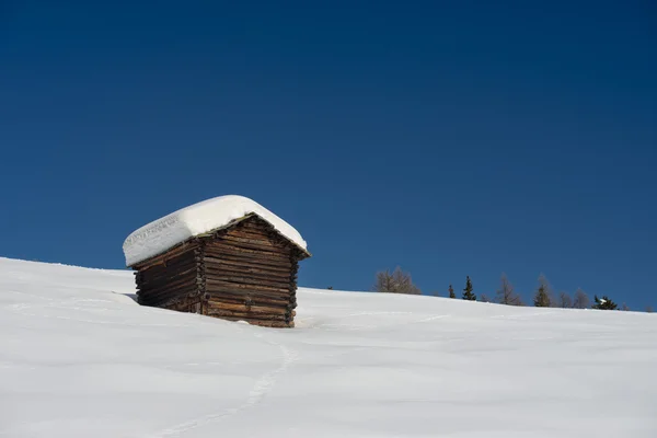 A wood cabin hut in the winter snow background