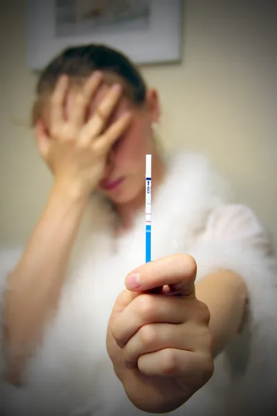 Depressed female with pregnancy test