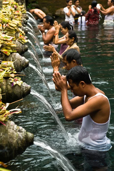 Unidentified persons pray and bath themselves in Tirta Empul, Bali, Indonesia
