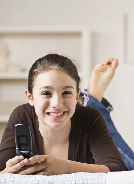 Smiling Teenager Holding Cellphone