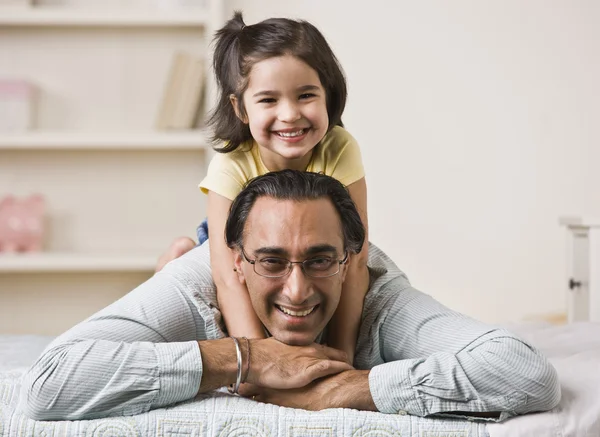 Girl Sitting on Fathers Back