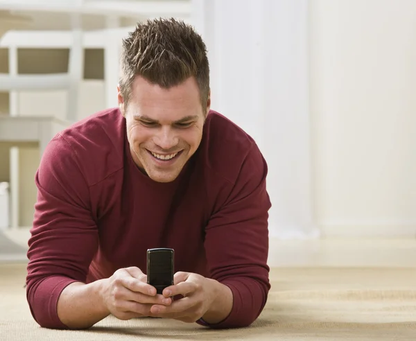 Attractive male with cell phone.