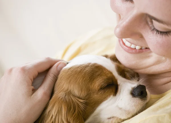 Young Woman Holding Dog