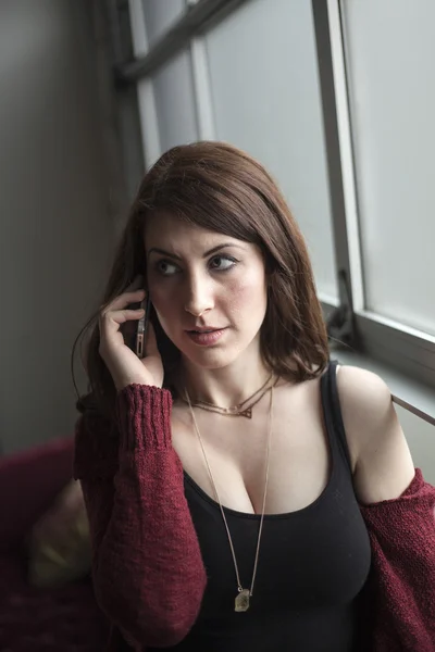 Beautiful Woman with Brown Hair and Blue Eyes Talks on Cell Phon