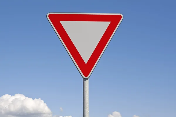 Give way. Traffic signs and blue sky