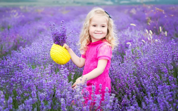 Happy little girl is in a lavender field