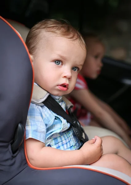 Cute toddler boy in car seat