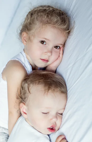 Charming little brother and sister asleep