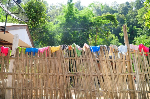 Bamboo fence to be cloth line in local village, North Thailand.