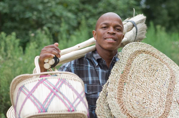 Stock photograph of South African entrepreneur small business broom salesman