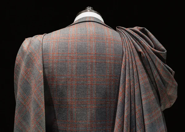 Mannequin in checkered suit with fabric folds