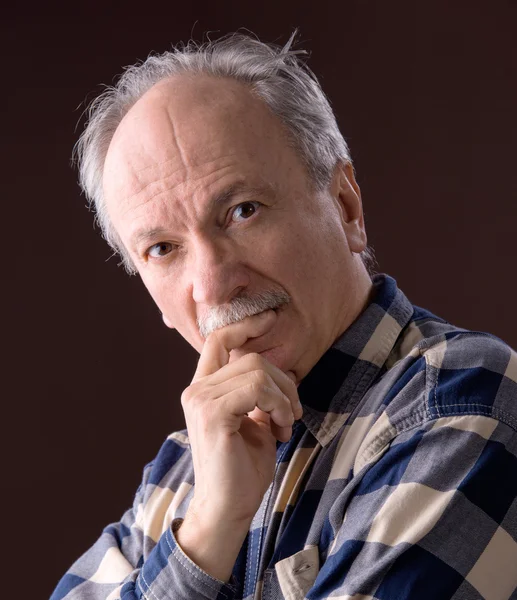 Elderly man on a brown background