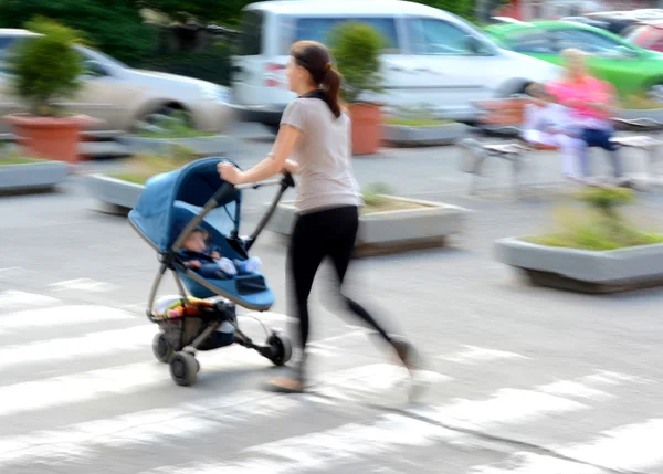 Mother with toddler son in stroller