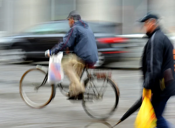 Cyclist in motion riding down the street