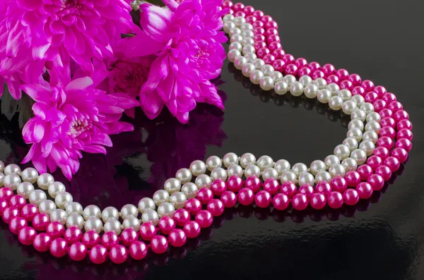 Pearl necklace and bouquet of chrysanthemums
