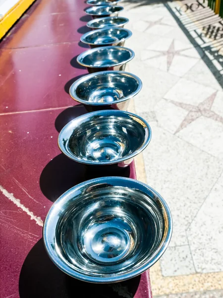 Prayer silver bowls in the row, Dharmshala — Stock Photo #28352335