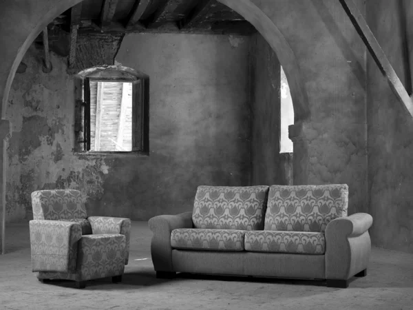 Sofa and armchair in a big empty interior