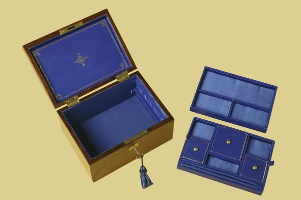 Old jewelry box with compartments on blue velvet
