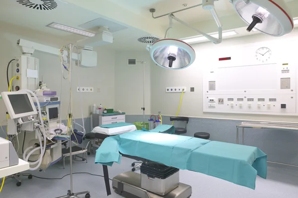Surgery room with bed and machinery.