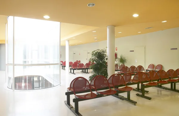Waiting room area with metallic red chairs
