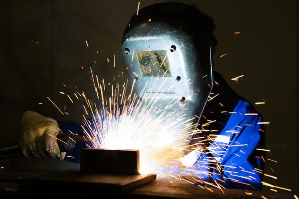 Man welding steel creating many sparks
