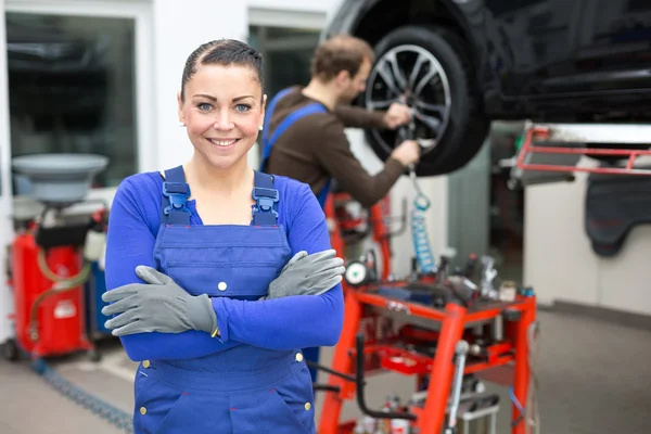 Female mechanic standing in a garage