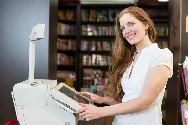 Cashier at cash register in bookstore