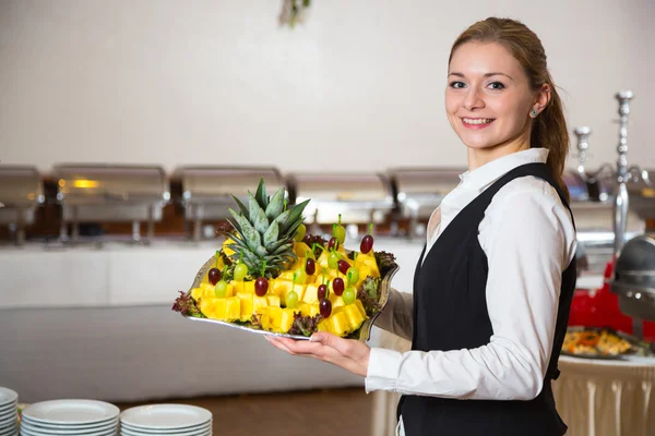 Catering service employee or waitress with a tray of appetizers