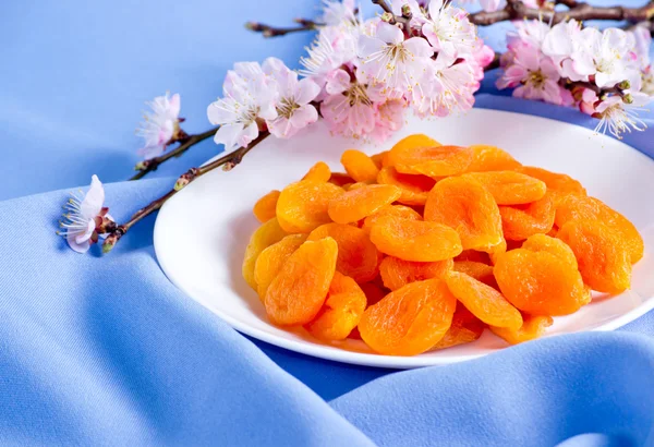 Dried apricots with almonds and blossoming branch