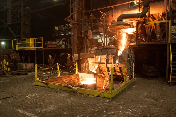 Smelting iron at high temperature in a steel mill.