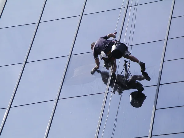 Man cleaning windows on a high rise building