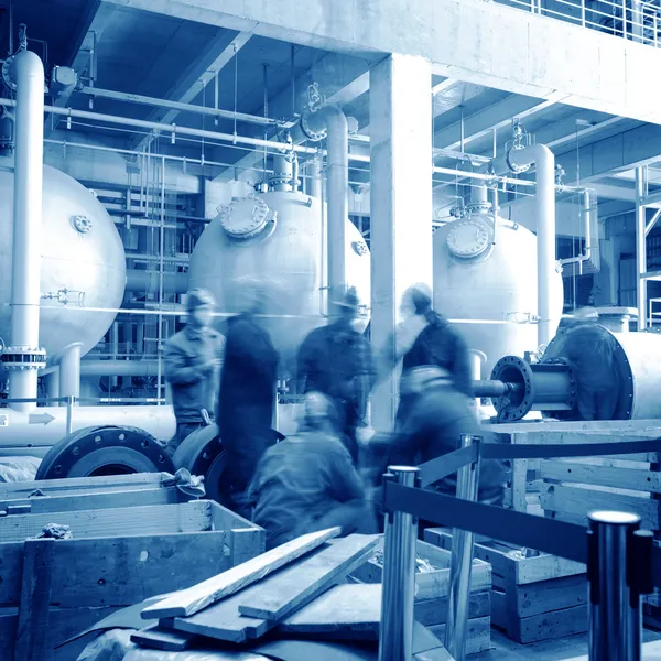 Maintenance engineer checking technical data of heating system equipment in a boiler room