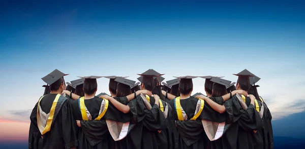 Back of chinese graduates with blue sky